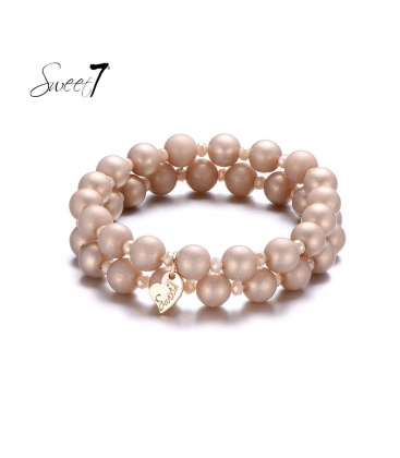 Armband van kleine en grote naturelkleurige kralen