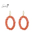 Oranje oorhangers met glas steentjes