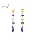 Blauwe oorhangers en met goudkleurige details 