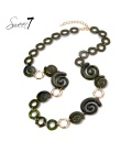 Halsketting met groene spiralen en goudkleurige cirkels