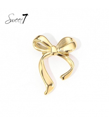 Goudkleurige broche met een elegante strik