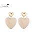 Oorbellen met beige kleurig hart en gouden detail