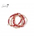 Armband met rode kralen en goudkleurige accenten