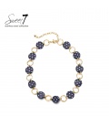 Halsketting donkerblauw met witte stippen en goudkleurige schakels