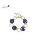Armband met donkerblauwe schijfjes, stippen en goudkleurige schakels.